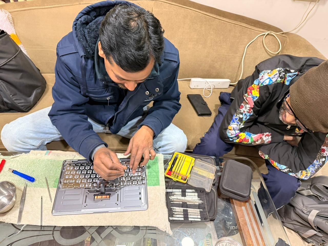 Daakshika Infotech technician repairing a laptop keyboard